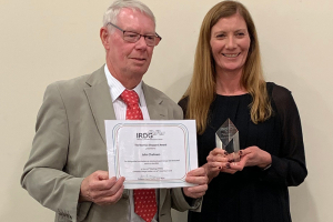 Photo of John Chalmers receiving the Award from Karen Faulds