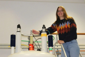 Photo of Anika Mauel on top of spectrometer magnet