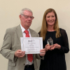 Photo of John Chalmers receiving the Award from Karen Faulds